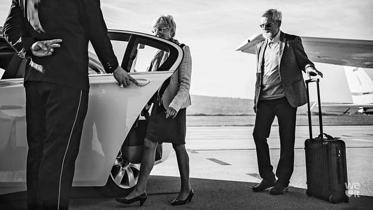 Couple enjoying a private chauffeured ride inside a high-end vehicle